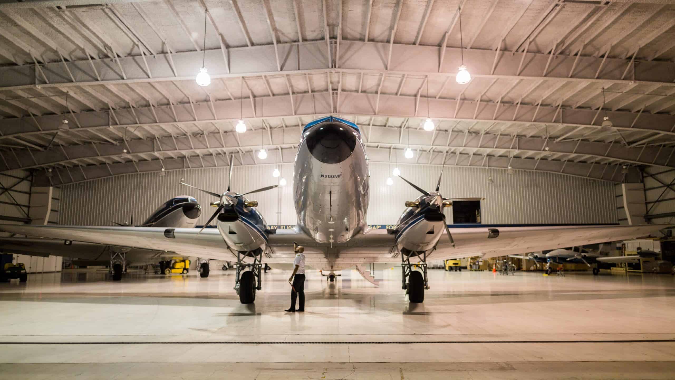 Twin engine, chromed prop plane in a hangar