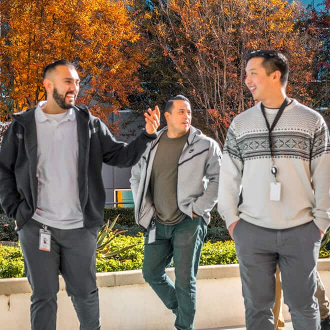 A group of employees walking outside, while talking