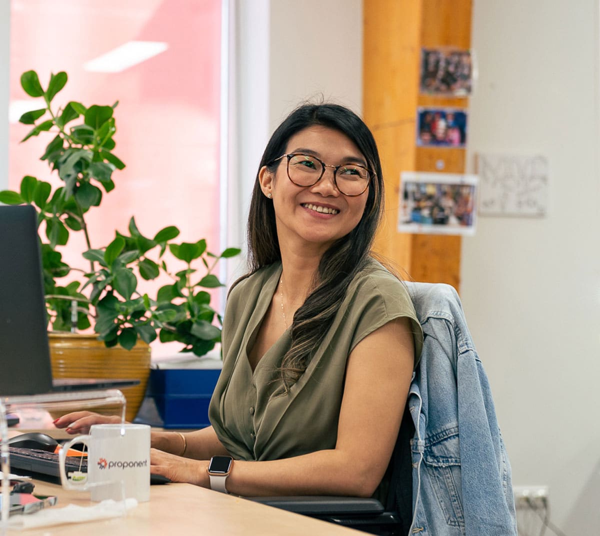 A smiling employee at their desk