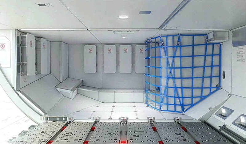Interior of an aeroplane cargo bay, with blue netting